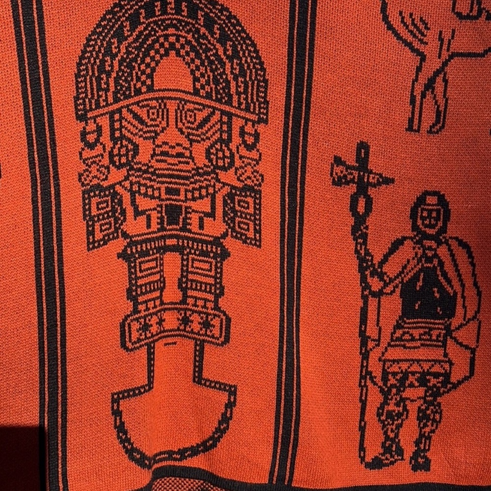 Vibrant Orange Poncho with Black Graphic Design